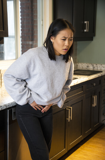 Woman suffering with stomach pain
